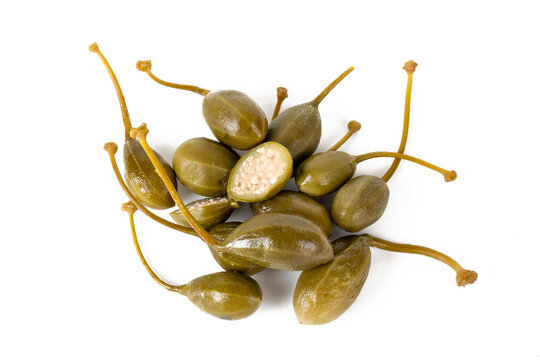 Capers (Capparis spinosa), edible flower buds pile isolated on white background
