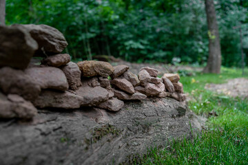 Rustic Stone Wall in Lush Green Forest.