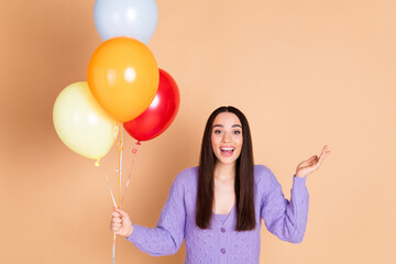 Portrait of nice young woman balloons wear cardigan isolated on beige color background