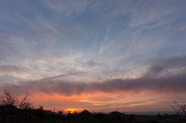 Landscape at sunset. Tragic gloomy sky. Panorama. Crimson twilight.