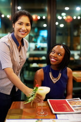 Customer, portrait and waiter with cocktail in restaurant, diner and consumer service in bistro. Black woman, drink and female server with smile for assistance, bartender and hospitality or dining