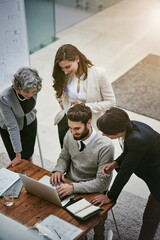 Above, laptop and business people in office for project, planning and documents in modern agency. Team, collaboration and tech in workplace for support, partnership and brainstorming for strategy