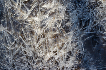 Background with growing ice on a pond in full frame