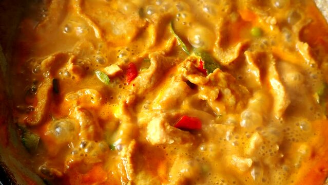 Cooking Panang curry with pork in pan , Thai famous food.