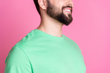 Close up photo of toothy beaming guy with stylish beard dressed green t-shirt demonstrate stubble isolated on pink color background