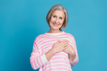 Photo portrait of lovely pensioner lady touch heart chest dressed stylish striped garment isolated...