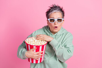 Photo of funky shocked lady dressed khaki sweatshirt enjoy film pop corn empty space isolated pink color background