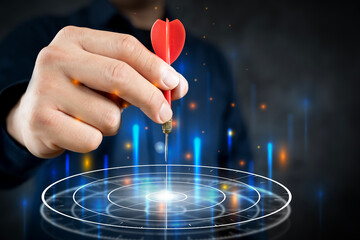 Businessman throwing red arrow dart to virtual target dart board.