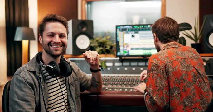 Men, partners and music producer in recording studio for sound or audio mixing with equipment. Artist, dj and creativity with teamwork or collaboration with headphones for composition and production
