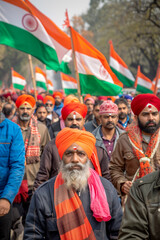 Fototapeta premium Group of proud Indian men in orange turbans waving the Indian flag in a demonstration march. 