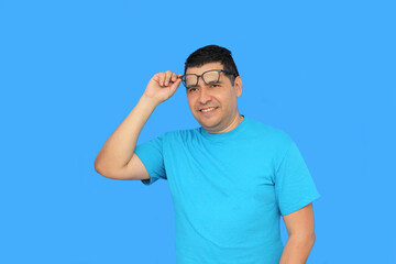 A 40-year-old dark-skinned Latino man uses eyeglasses to see better because he suffers from myopia...