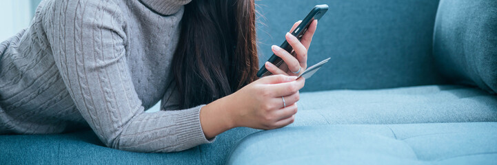 Banner Women sitting on sofa using smartphone, credit card to shopping online with smiling face...