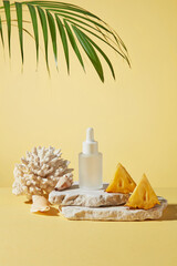 Photo for advertise cosmetics has tropical fruits ingredient like pineapple, a blank label serum bottle displayed on stone podium, next to some pieces of pineapple and coral, against yellow texture
