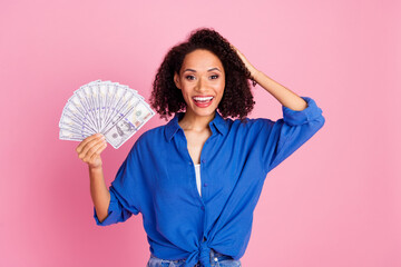 Photo of charming wealthy woman wear trendy blue clothes hand hold cash wow betting esport isolated on pink color background