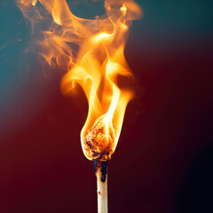 A close up image of a matchstick burning brightly against a gray background