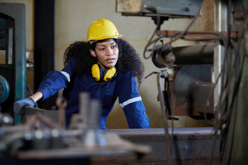 factory worker or technician checking and control lathe machine in factory