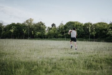 Person running through a grassy field at sunset, enjoying outdoor fitness and nature.