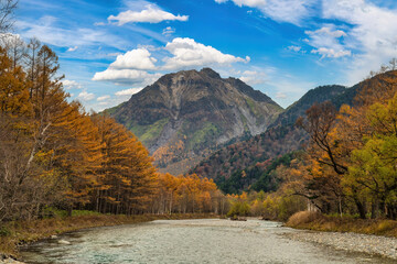 Nature landscape at Kamikochi Japan, autumn foliage season with pond and mountain