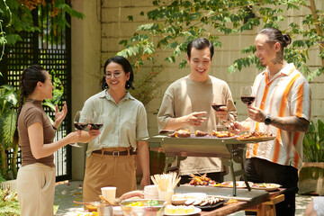 Young people having barbeque party on sunny day