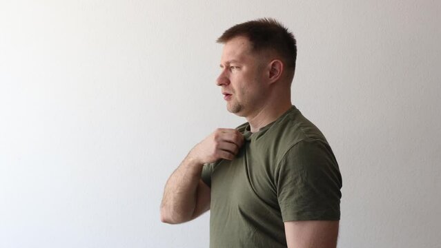 The man in the hackey shirt is hot and cooling off