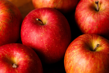 Ripe organic red apple on wooden table background.