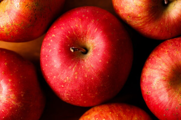 Ripe organic red apple on wooden table background.