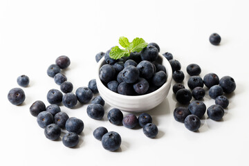 Ripe organic blueberries on white wooden table background. Selective focus.