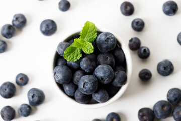 Ripe organic blueberries on white wooden table background. Selective focus.