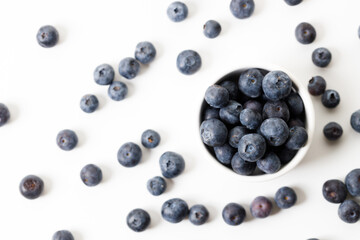 Ripe organic blueberries on white wooden table background. Selective focus.