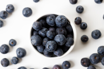 Ripe organic blueberries on white wooden table background. Selective focus.