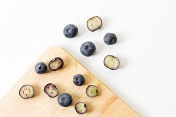 Ripe organic blueberries on white wooden table background. Selective focus.