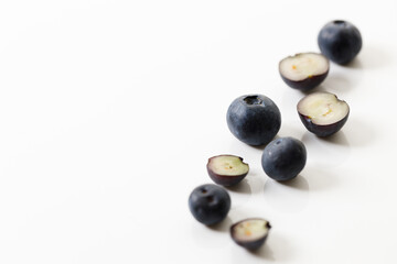 Ripe organic blueberries on white wooden table background. Selective focus.