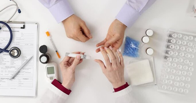 Hands of doctor and patient with glucometer diabetes concept top view