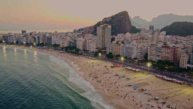 Copacabana beach and Rio de Janeiro mountains seen from above during summer sunset drone timelapse sunset