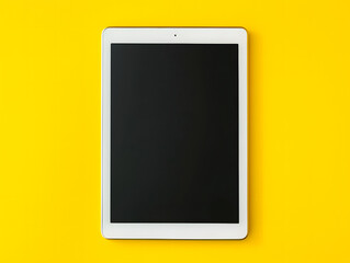 Top view of digital tablet with blank screen on a yellow background