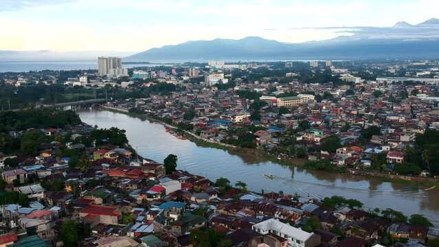 Unique drone aerial cinematic landscape and cityscape showcasing the skyline and city view of Davao, the capital city of Southern Mindanao, Philippines.