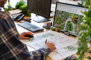 Keuken achterwand Grijs Landscape designer working in office with plans on paper near computer  © Di Studio