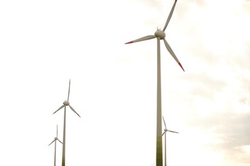 Fototapeta premium Wind turbine in agricultural fields under clear blue sky
