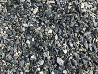 Black small road stone background, dark gravel pebbles stone texture seamless texture, granite,marble