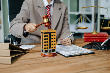 Real Estate Lawyer And House Foreclosure Law. House model, hammer judge gavel on table with white background. Foreclosure, bankruptcy concept