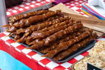 Traditional Georgian dessert churchkhela on display at market. Candies made from grape must, nuts, fruits