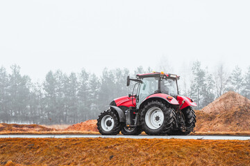 Tractor on a asphalt road driving to field