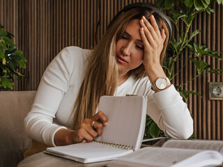 Woman struggling with ADHD and dyslexia, holding head in frustration, problems with reading. Learning difficulties and mental strain.