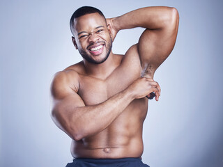 Black man, deodorant and apply in studio portrait, body care and armpit for grooming on blue...