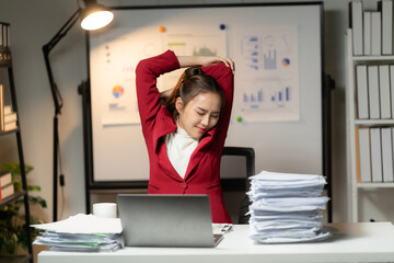 Business employee woman working in stacks paper files for checking unfinished achieves busy at work