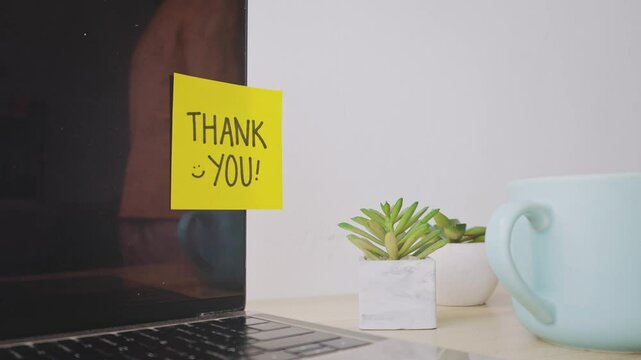 Young Man Leaving Notes Thank You On Computer Screen At Office