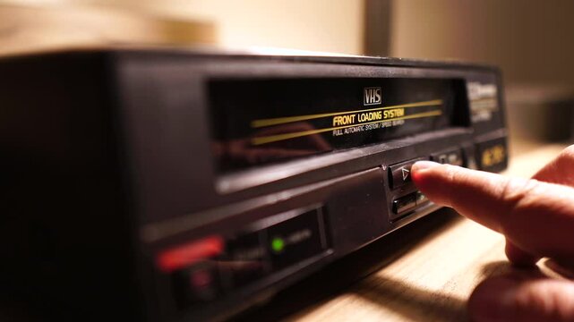 Inserting VHS Video Tape in Vintage Player From 1980's and Pressing Play Button, Close Up