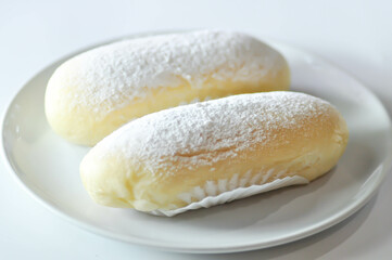 bun, bread or butter bread wih icing sugar