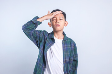 Little Boy Touching Head Having Headache and Problems Isolated on Gray Background