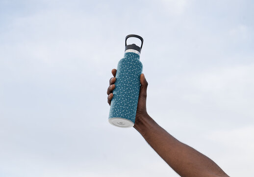 Mockup of man holding customized water bottle